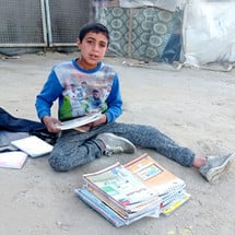 mohammed-al-nabaheen-sells-his-books-in-front-of-his-tent-in-deir-al-balah.jpg